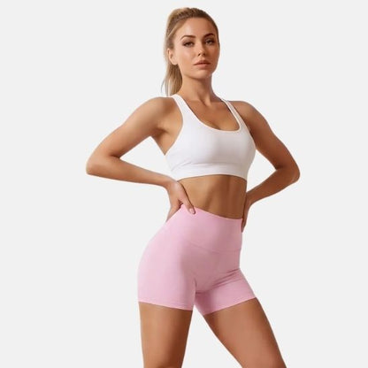 Short fitness femme rose – pose sportive fond neutre